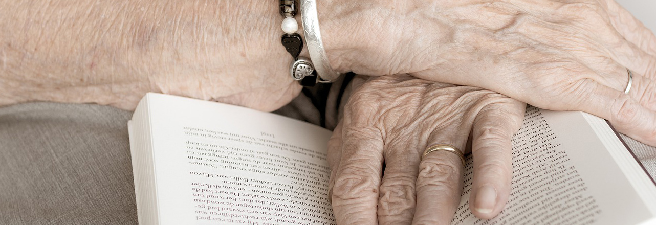 Older person holding book